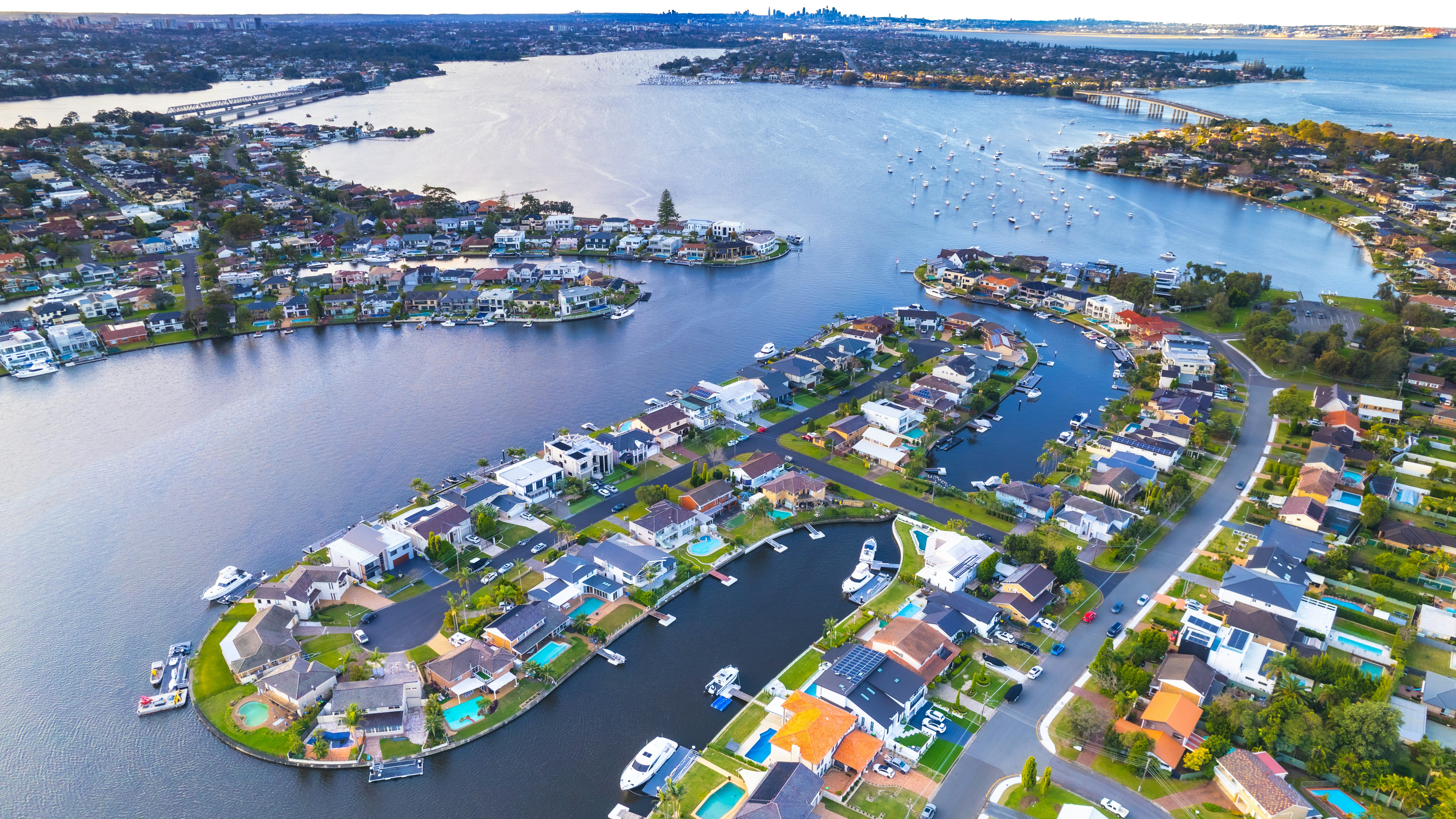 Aerial view of Sydney waterfront suburbs showing houses, canals and harbour lifestyle for choosing the best suburbs in Sydney
