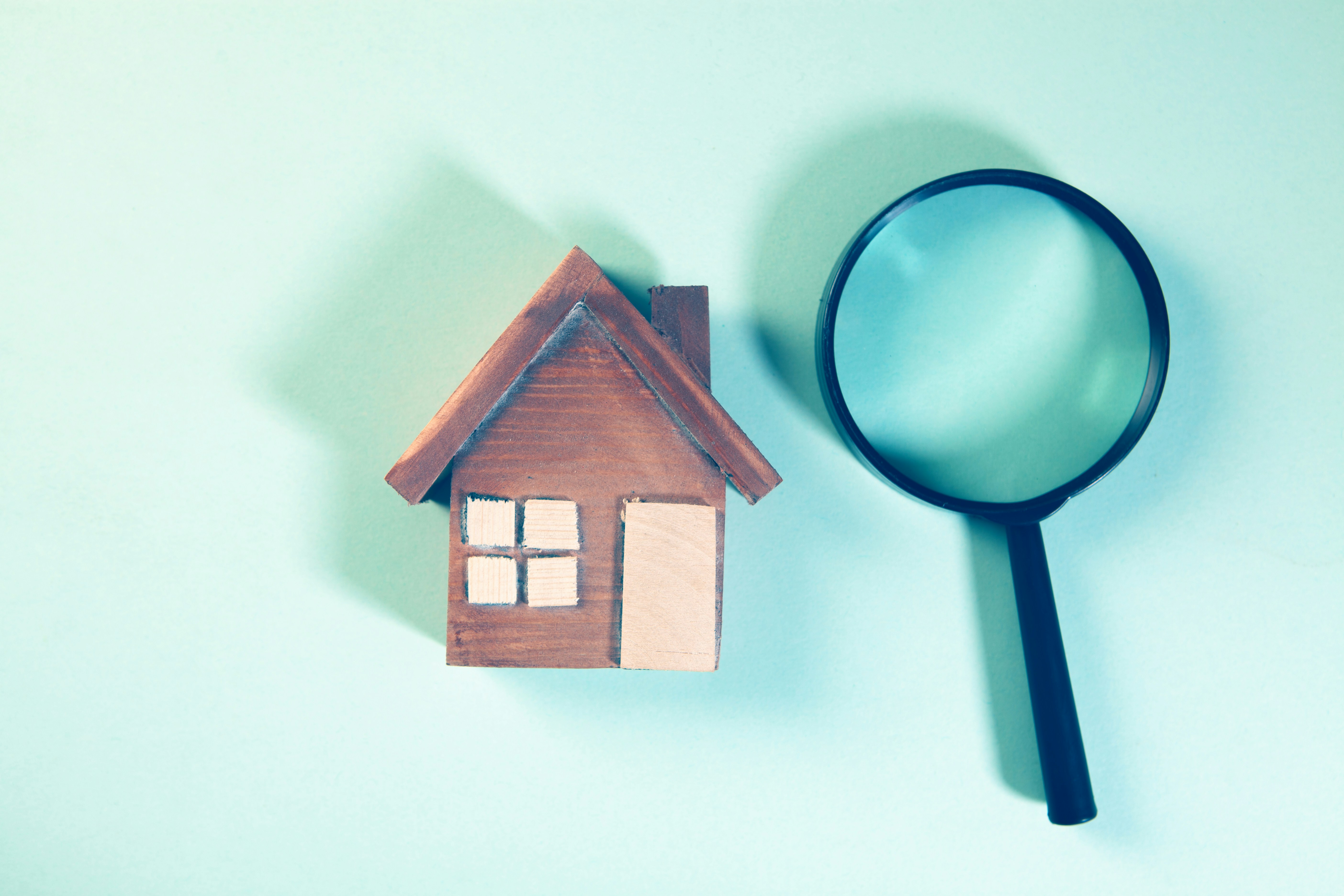 House inspection concept with magnifying glass showing how Sydney buyers can identify property defects and hidden issues
