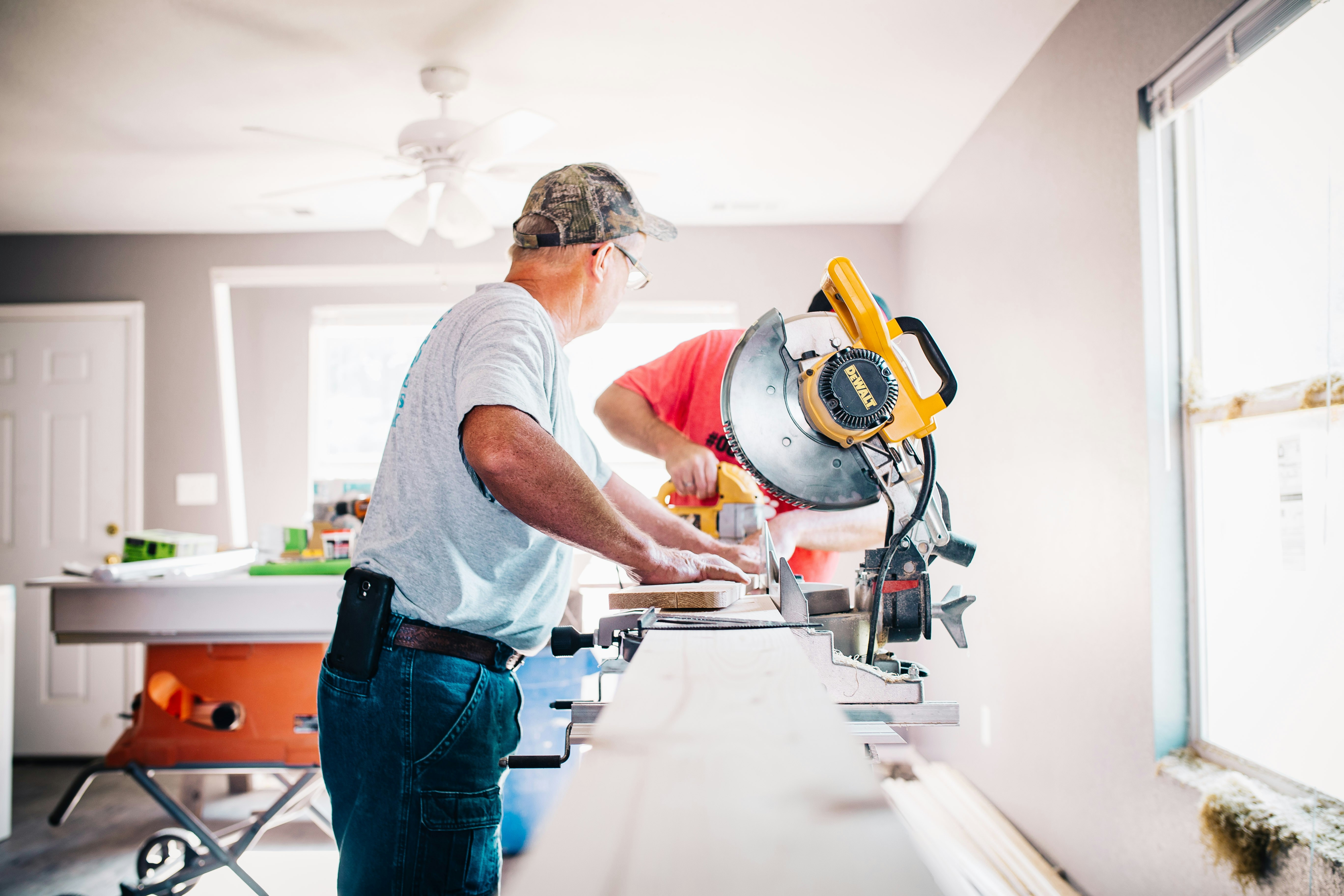 Tradespeople renovating a home interior showing building repairs, maintenance costs and inspection findings for Sydney property buyers