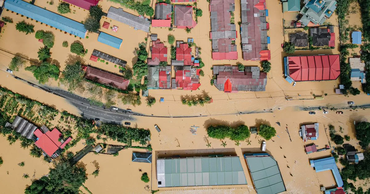 Aerial view of a residential area with streets and houses under floodwater